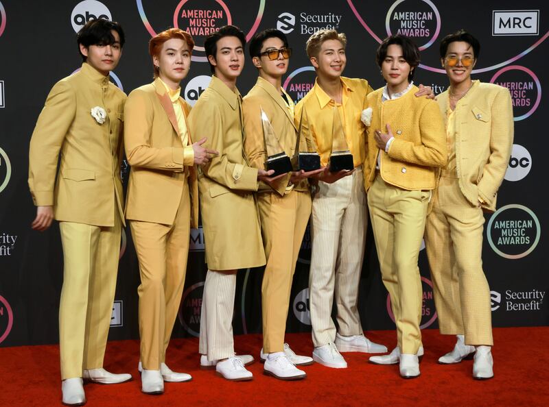 Jin, Suga, V, Jungkook, RM, Jimin, and J-Hope of BTS hold their award for the Favourite Pop Song, Favourite Duo or Group and Artist of the Year awards during the 2021 American Music Awards. Reuters 