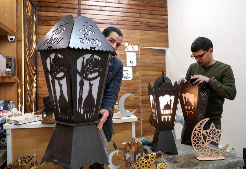 Palestinian craftsmen from the Shawer family make traditional lanterns before the start of Ramadan, at the family's wood workshop in the Israeli occupied West Bank town of Hebron. AFP