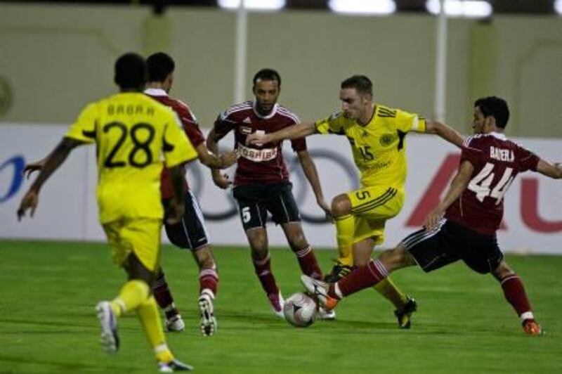 16/09/10 - Abu Dhabi, UAE -   Gregory Dufrennes, #15, of Kalba, tries to get by Al Ahli defenders at Kabla Union Sports and Cultural Club on Thursday September 16, 2010.  Kalba tied Al Ahli 2 - 2.  (Andrew Henderson / The National)
