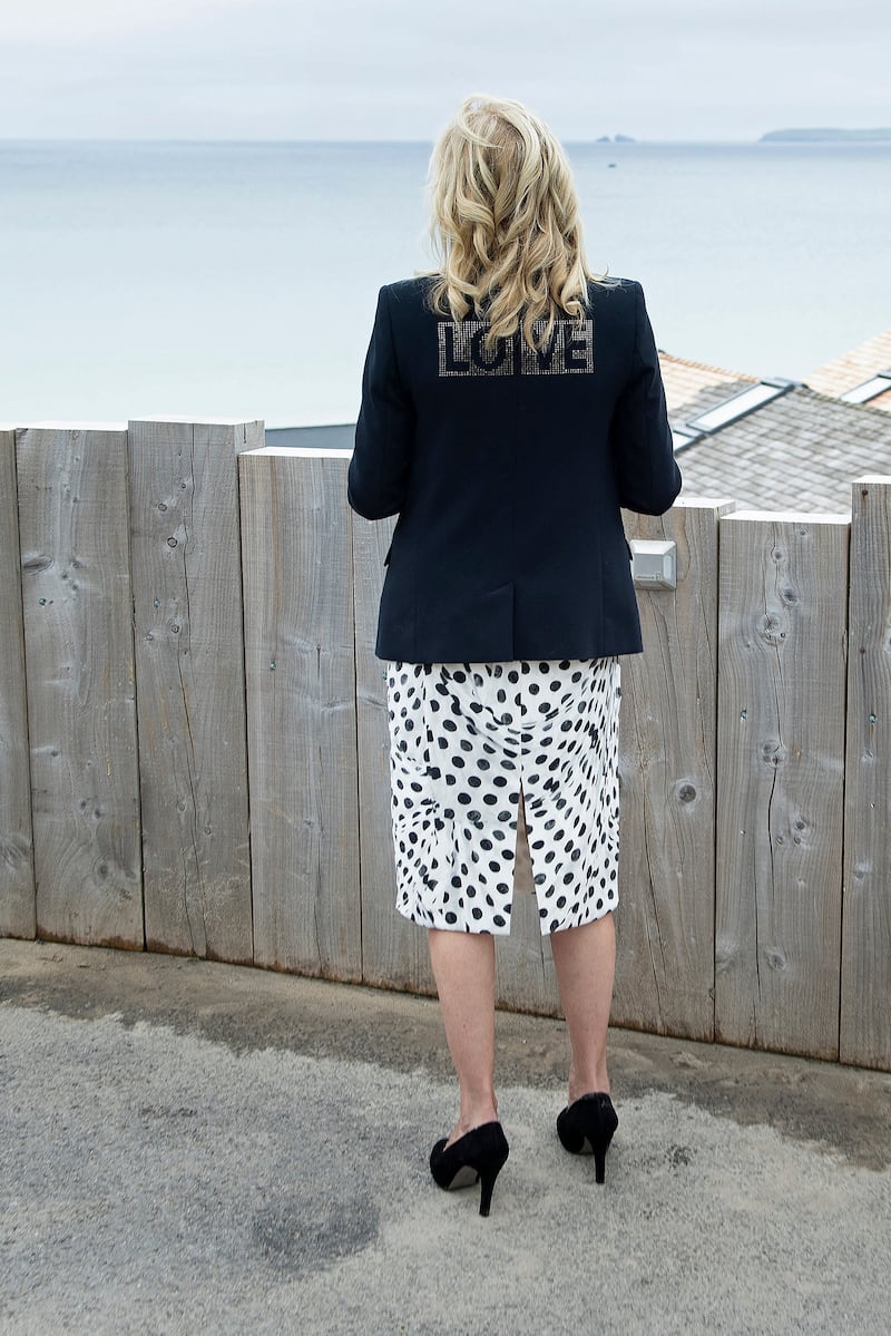 Jill Biden, wearing a Brandon Maxwell jacket with the word 'love' on the back with a Brandon Maxwell dress, in Cornwall, England on June 10, 2021. AFP