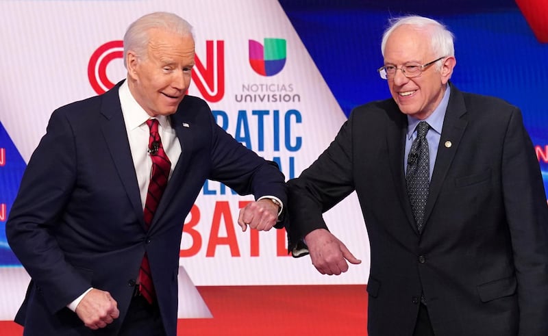 Democratic U.S. presidential candidates former Vice President Joe Biden and Senator Bernie Sanders do an elbow bump in place of a handshake as they greet other before the start of the 11th Democratic candidates debate of the 2020 U.S. presidential campaign, held in CNN's Washington studios without an audience because of the global coronavirus pandemic, in Washington, U.S. March 15, 2020. REUTERS/Kevin Lamarque