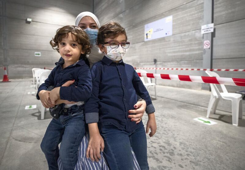 Abu Dhabi, United Arab Emirates, March 18, 2021.  A mother takes her children, Ryan Al Mulla, 6 and Omar, three years old, to get saliva tested at the Biogenix lab at G42 in Masdar City. 
Victor Besa/The National
Section:  NA
Reporter:  Shireena Al Nowais
