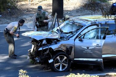 Los Angeles County Sheriffs inspect the vehicle of Tiger Woods, who was rushed to hospital after suffering multiple injuries. Reuters