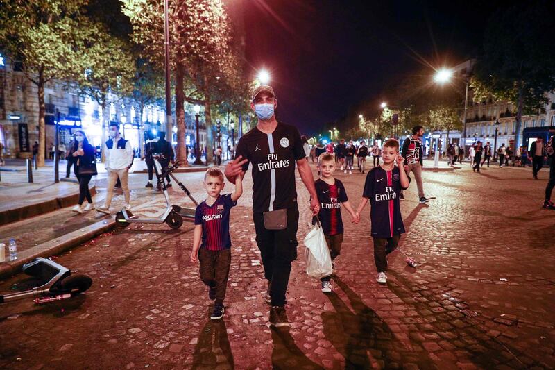 PSG supporters walk on the Champs-Elysees in Paris. AFP