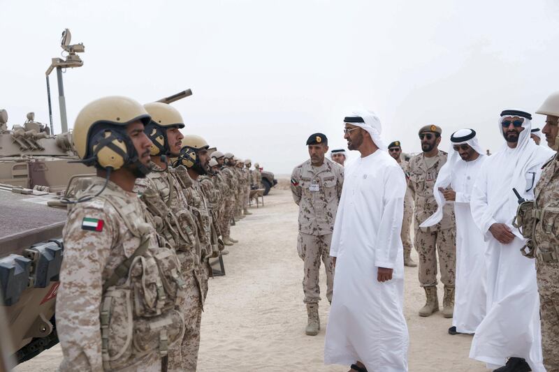 AL DHAFRA REGION, ABU DHABI, UNITED ARAB EMIRATES - April 08, 2018: HH Sheikh Mohamed bin Zayed Al Nahyan Crown Prince of Abu Dhabi Deputy Supreme Commander of the UAE Armed Forces (5th R),   speaks with a member of the UAE Armed Forces, during a military exercise titled ‘Homat Al Watan 2 (Protectors of the Nation)’, at Al Hamra Camp. Seen with HH Major General Pilot Sheikh Ahmed bin Tahnoon bin Mohamed Al Nahyan, Chairman of the National and Reserve Service Authority (6th R), HE Staff Major General Juma Al Bowardi, Commander of the UAE Armed Forces Land Forces (4th R), HH Sheikh Nahyan Bin Zayed Al Nahyan, Chairman of the Board of Trustees of Zayed bin Sultan Al Nahyan Charitable and Humanitarian Foundation (3rd R) and HE Mohamed Ahmad Al Bowardi, UAE Minister of State for Defence Affairs (2nd R).

( Rashed Al Mansoori / Crown Prince Court - Abu Dhabi )
---