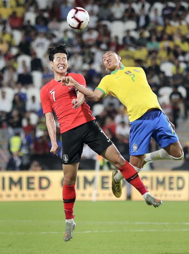 Abu Dhabi, United Arab Emirates - November 19, 2019: Brazil's Richarlison and South Korea's Son Heung-min during the game between Brazil and South Korea. Tuesday, November 19th, 2017 at Mohammed Bin Zayed Stadium, Abu Dhabi. Chris Whiteoak / The National