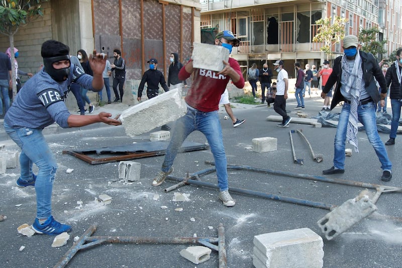 Demonstrators throw pieces of concrete during a protest against growing economic hardship in Beirut, Lebanon. REUTERS