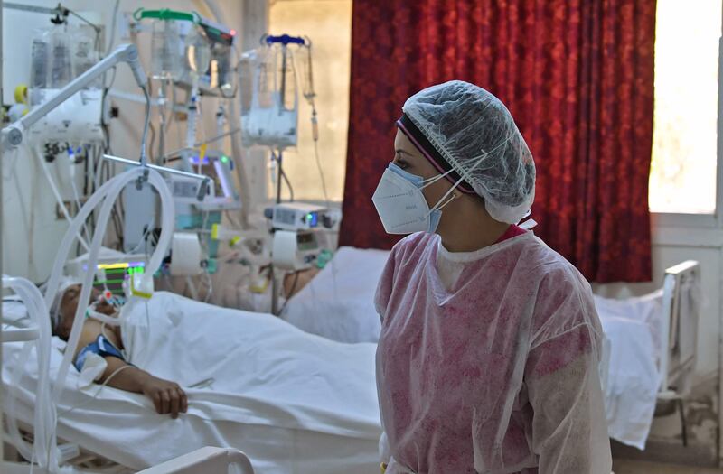 A Tunisian medic attends to patients at a gym that was converted to deal with a surge in new Covid-19 cases in the east-central city of Kairouan.