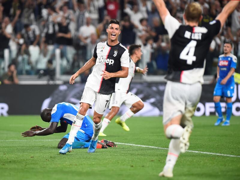 Soccer Football - Serie A - Juventus v Napoli - Allianz Stadium, Turin, Italy - August 31, 2019   Napoli's Kalidou Koulibaly looks dejected after scoring an own goal and Juventus' fourth as Juventus' Cristiano Ronaldo and Matthijs de Ligt celebrate   REUTERS/Massimo Pinca