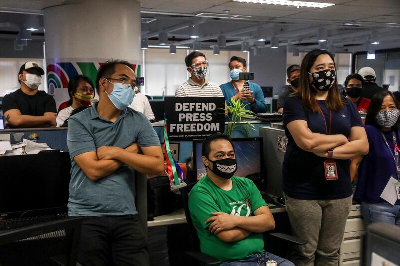 Employees watch a live footage of the hearing on the ABS-CBN franchise renewal at the network's headquarters in Quezon City. EPA