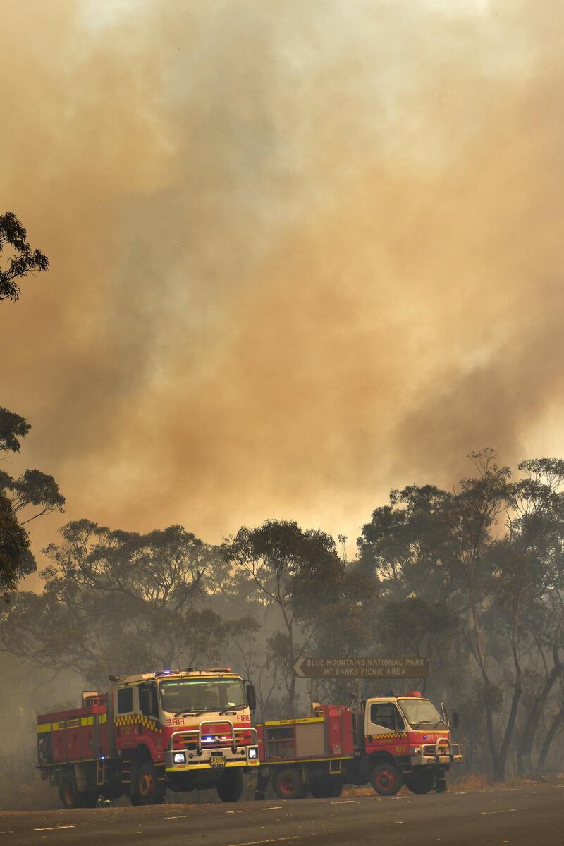 New South Wales Rural Fire Service and Fire and Rescue NSW crews work to contain the Gospers Mountain fire in the Blue Mountains National Park, north west of Sydney, Australia.  EPA