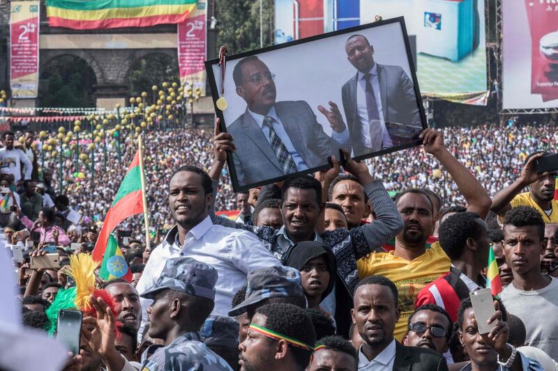 Supporters of Ethiopia Prime Minister attend a rally on Meskel Square in Addis Ababa on June 23, 2018. One person died and scores of others were hurt after a grenade blast at new Ethiopian Prime Minister Abiy Ahmed's first mass rally in the capital that sent crowds fleeing in panic. Abiy had just wrapped up his speech before tens of thousands of people in the heart of Addis Ababa when the explosion went off, sending droves of supporters towards the stage as the prime minister left hurriedly, an AFP correspondent said.
 / AFP / YONAS TADESSE
