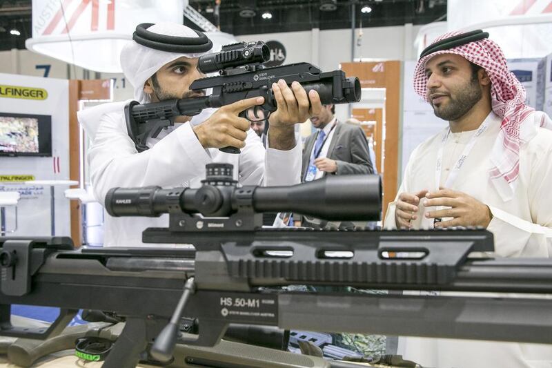 Men check out guns made by Steyr Mannlicher at the exhibition at IDEX 2015. Silvia Razgova / The National