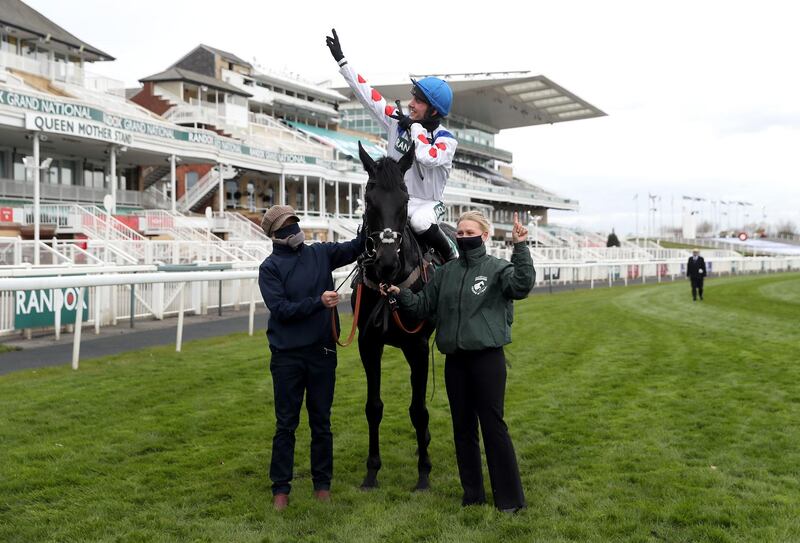 Jockey Harry Cobden celebrates after winning the Juvenile Hurdle on Monmiral. PA