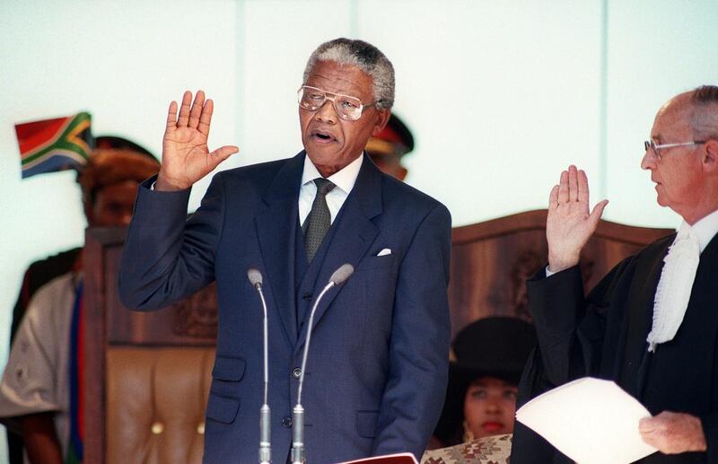 May 10, 1994: Mandela takes the presidential oath during his inauguration at the Union Building in Pretoria. Mandela was elected president at the first session of the country’s post-apartheid parliament. Walter Dhladhla / AFP Photo