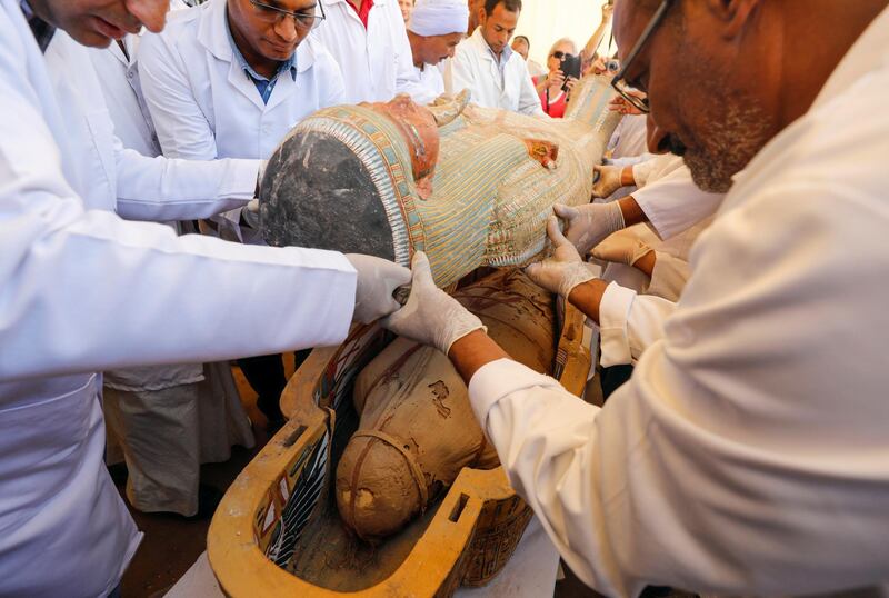 Archaeologists remove the cover of an ancient painted coffin discovered at Al Asasif Necropolis in the Vally of Kings in Luxor, Egypt. Reuters
