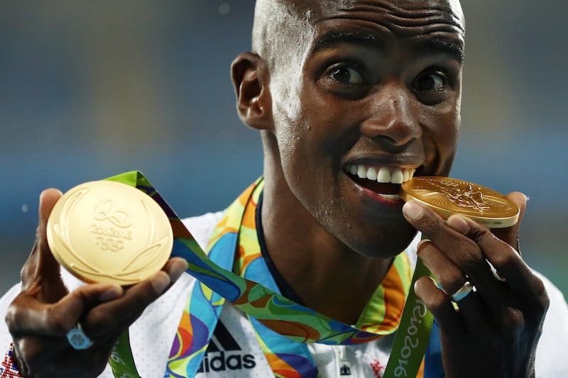 Farah holds both his 5,000m and 10,000m gold medals on the podium at the Rio 2016 Olympic Games in Brazil. Getty Images