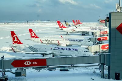 Turkish Airlines planes are seen parked at gates amid heavy snow at Istanbul Airport. Getty Images