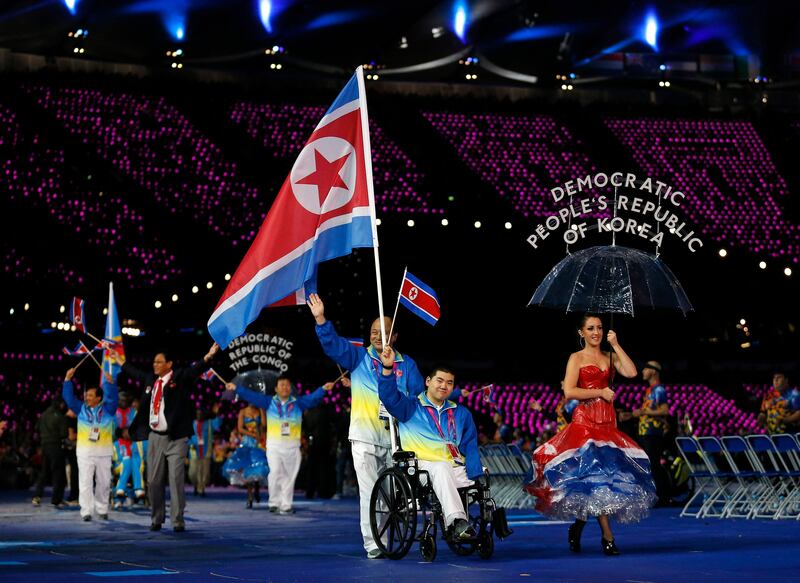 North Korea's flagbearer swimmer Ju Song Rim waves as he enters the arena during the Opening Ceremony for the 2012 Paralympics in London, Wednesday Aug. 29, 2012.  (AP Photo/Matt Dunham) *** Local Caption ***  London Paralympics Opening Ceremony.JPEG-043b1.jpg