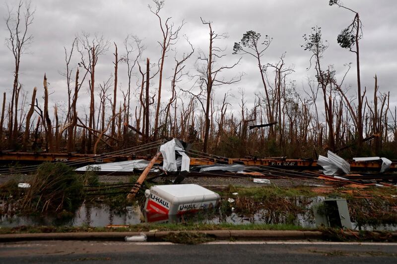 Shredded trees, derailed train cars and a sunken trailer are seen in the aftermath of Hurricane Michael in Panama City, Florida. AP Photo