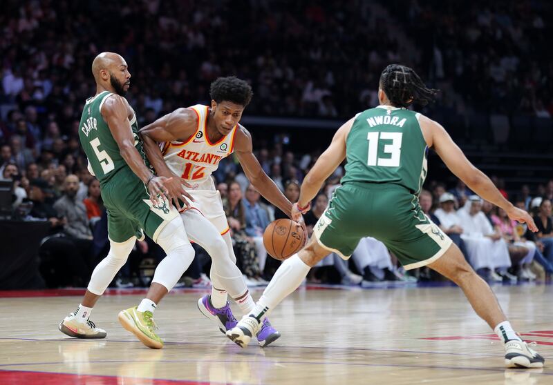 Hawks' De'Andre Hunter  takes on Jevon Carter of Milwaukee Bucks.  