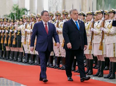 Hungarian Prime Minister Viktor Orban, right, and his Chinese counterpart Li Qiang inspect a guard of honour during a welcome ceremony at the Great Hall of the People in Beijing, on Monday.  AP