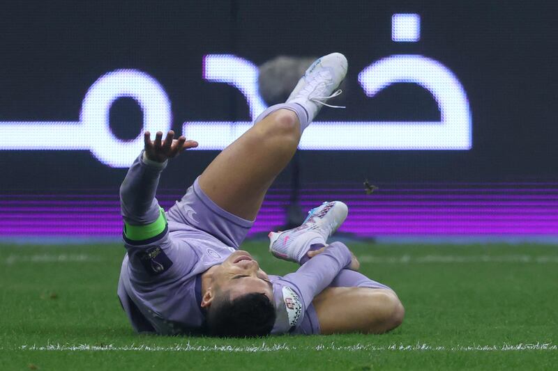 Al Nassr's Portuguese forward Cristiano Ronaldo lays on the pitch injured. AFP