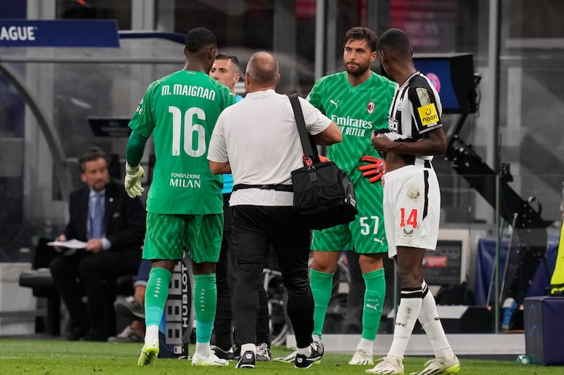 AC Milan's goalkeeper Mike Maignan, left, is replaced by Marco Sportiello. AP