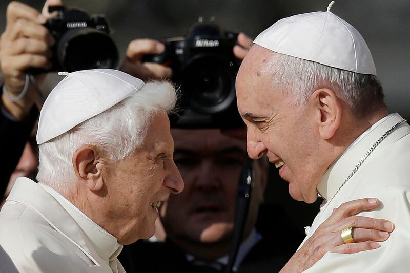 FILE - In this Sunday, Sept. 28, 2014 file photo, Pope Francis, right, hugs Emeritus Pope Benedict XVI prior to the start of a meeting with elderly faithful in St. Peter's Square at the Vatican. Emeritus Pope Benedict XVI has marked the eighth anniversary of his historic resignation by insisting in an interview published in Corriere della Sera Monday, March 1, 2021, that he stepped down knowingly and that â€œthere is only one popeâ€ _ Francis. (AP Photo/Gregorio Borgia, File)