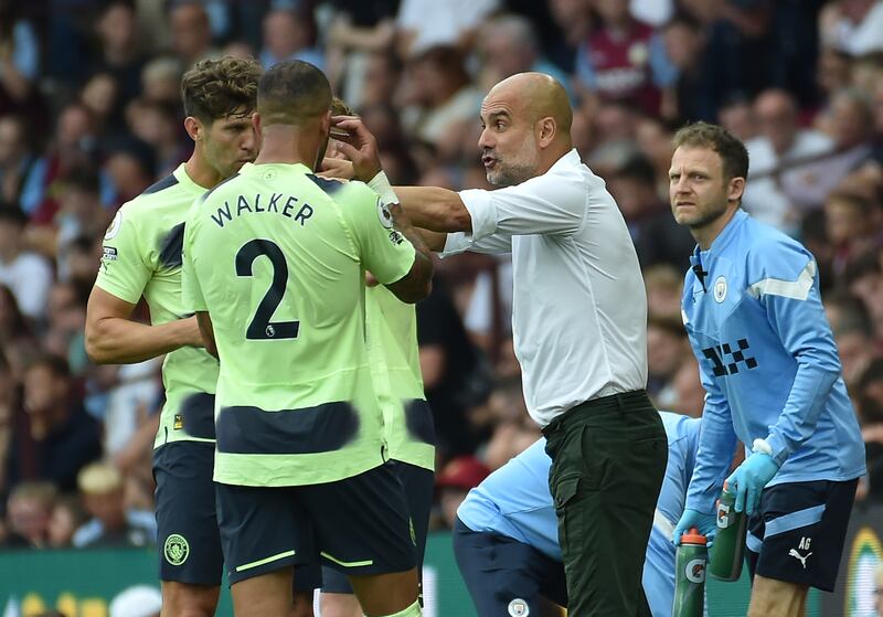 Manchester City coach Pep Guardiola talks to his players. AP