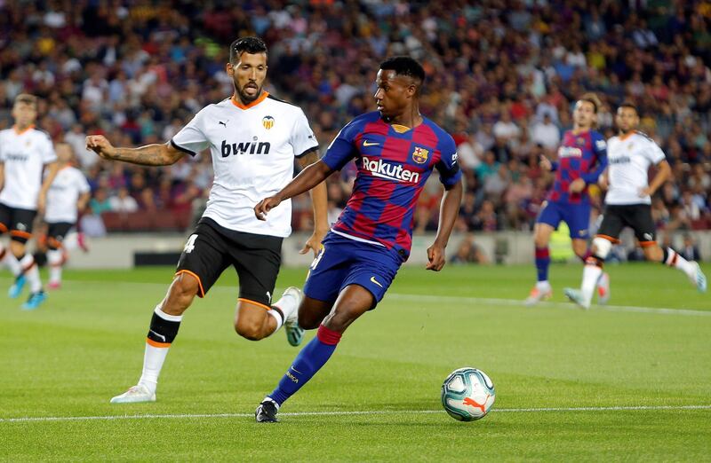 Barcelona's Ansu Fati in action against Valencia's Ezequiel Garay. EPA