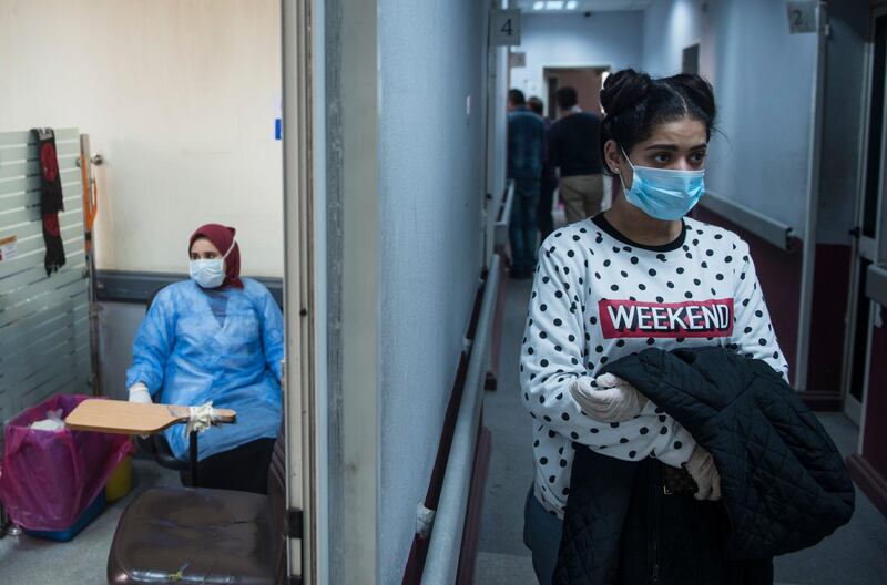 A woman waits to take a Covid-19 test at the Central Public Health Laboratories in Cairo, Egypt.  EPA