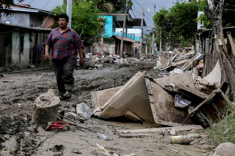 A man walks along a damaged street after the passage of Hurricane Eta in La Lima, Cortes, Honduras as Hurricane Iota -- upgraded to Category 5 -- moves over the Caribbean towards the Nicaragua-Honduras border. AFP