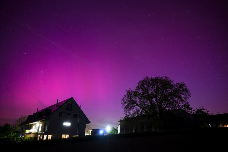The Northern Lights in the night sky above the village of Daillens, Switzerland. EPA