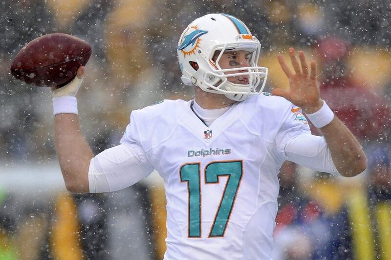 Miami quarterback Ryan Tannehill attempts to throw in the snow. A native of Texas in his second year as a pro with the Dolphins, Tannehill had never played in the snow before Sunday. Don Wright / AP