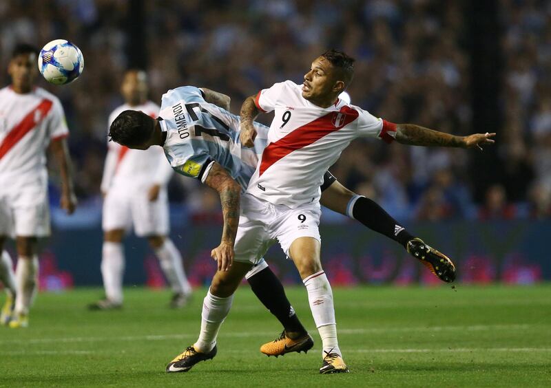 Argetina defender Nicolas Otamendi and Peru forward Paolo Guerrero tussle for the ball. Marcos Brindicci / Reuters