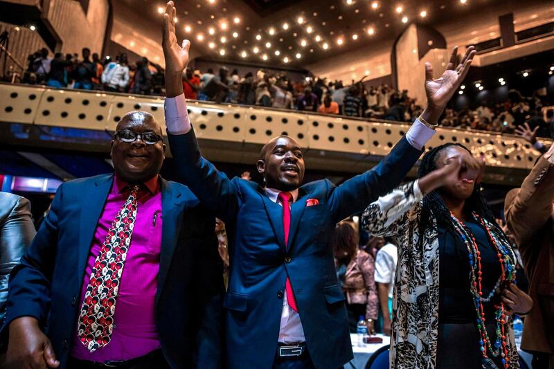 Zimbabwe's members of parliament celebrate after Mugabe's resignation on November 21, 2017 in Harare. Jekesai Njikizana / AFP