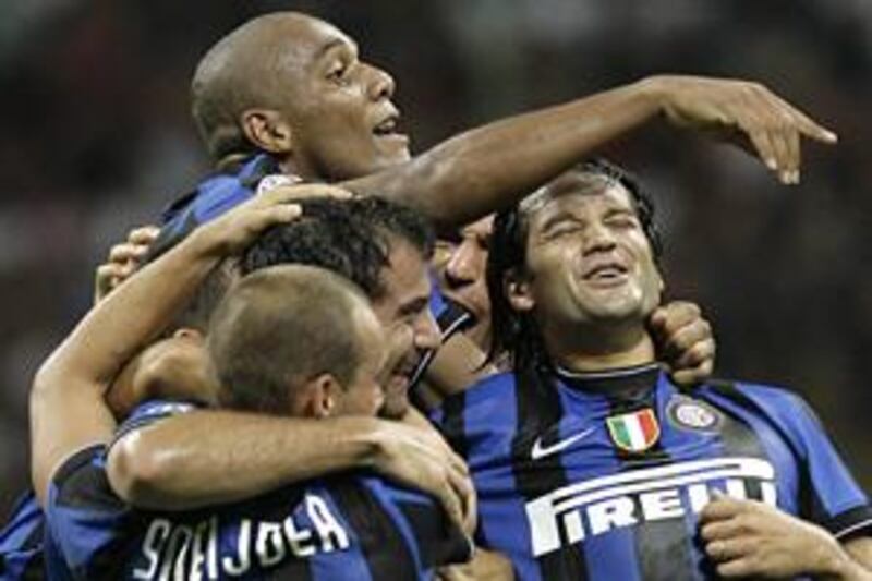 Inter Milan's Dejan Stankovic, centre, celebrates with his teammates after scoring the fourth goal against AC at the San Siro.