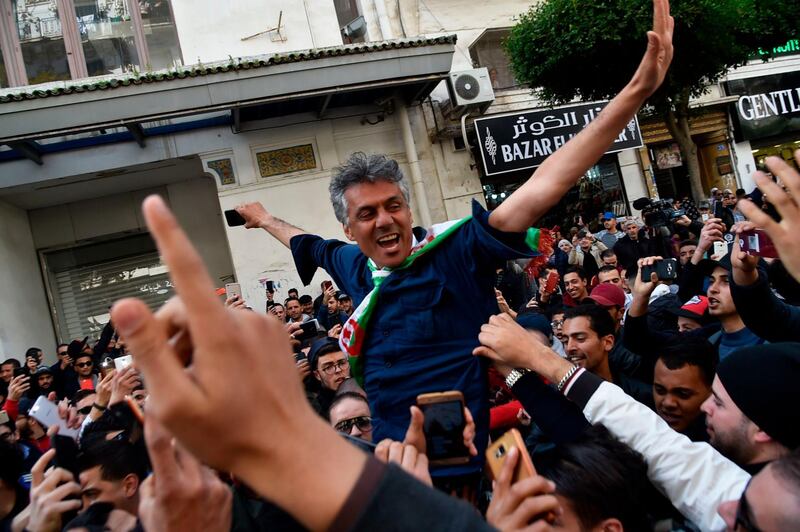 Algerian businessman and political activist Rachid Nekkaz (centre) arrives in front of the city hall of Algiers during a gathering for his  supporters. AFP