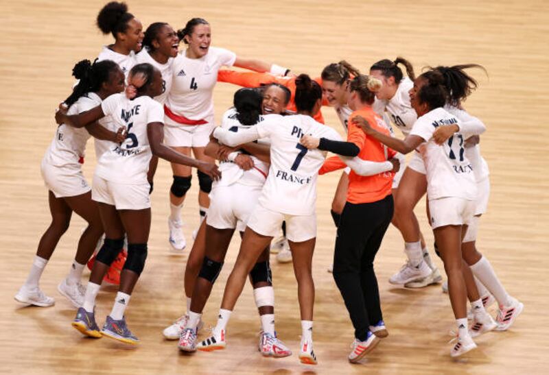 Team France celebrates victory over Team ROC 30-25 to win the gold medal in Women's Handball on day sixteen of the Tokyo 2020 Olympic Games at Yoyogi National Stadium.