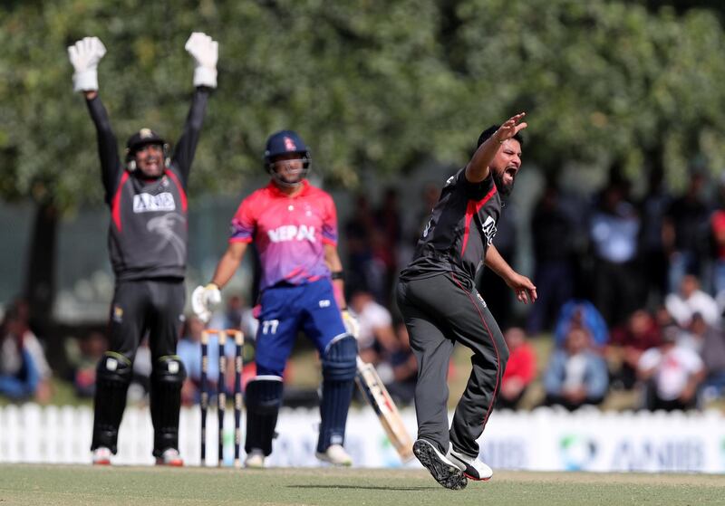 Dubai, United Arab Emirates - January 26, 2019: Imran Haider of the UAE takes the wicket of Paras Khadka of Nepal in the the match between the UAE and Nepal in a one day internationl. Saturday, January 26th, 2019 at ICC, Dubai. Chris Whiteoak/The National