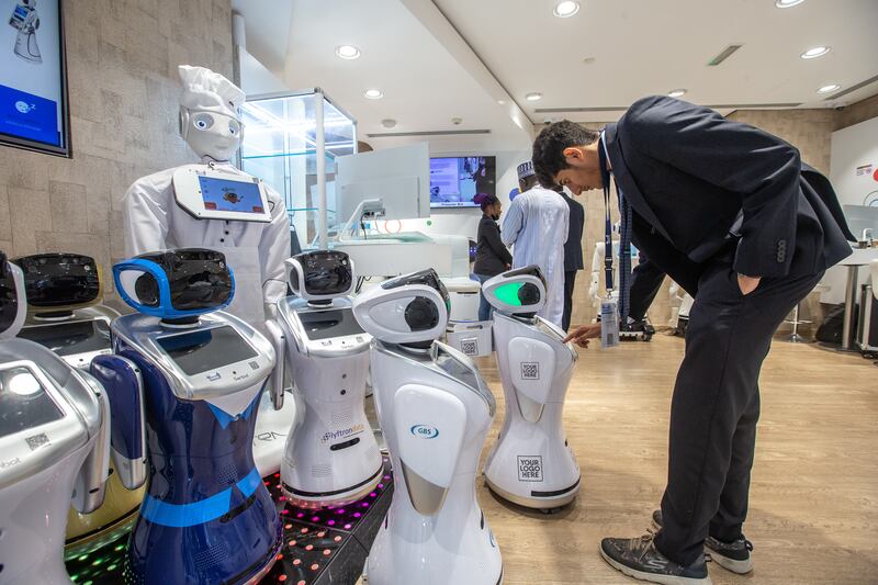 A visitor looks at robots on display at Experthub Robotics' stand.