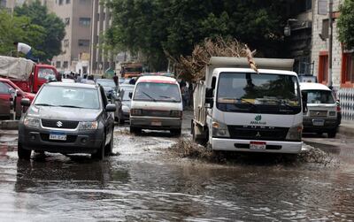 epa06693760 Cars drive through a flooded street after a flash flood affected Cairo, Egypt, 26 April 2018. Recent rainfalls have flooded parts of Egypt, temperatures dropped to six degrees Celsius.  EPA/KHALED ELFIQI