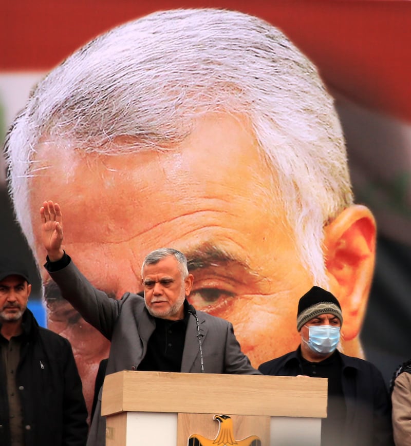 Hadi Al Amiri, centre, head of Badr Organisation, waves to his supporters during the rally, held in the Iraqi capital. Members and supporters the Popular Mobilisation Forces, a group of Shiite militias in Iraq, attended a rally to commemorate Suleimani and Al Muhandis, who died on January 3, 2020. EPA