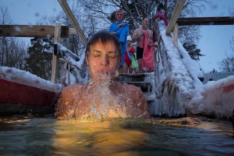 A Russian Orthodox Christian takes an icy dip during Epiphany celebrations in St Petersburg, Russia. AP Photo