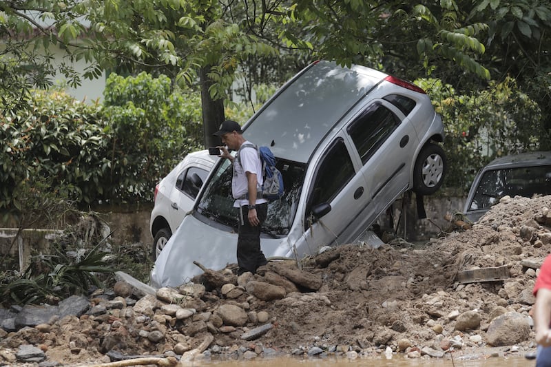 Heavy rains set off mudslides and floods in a mountainous region of Rio de Janeiro state, killing people and damaging property. EPA