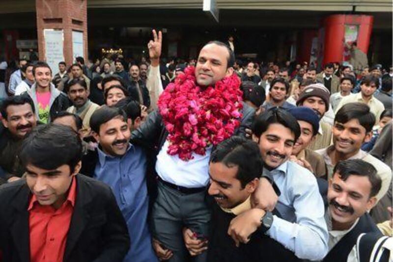 The Pakistani singer Muhammad Shahid Nazir, centre, is greeted by supporters on his arrival in Lahore. Arif Ali / AFP