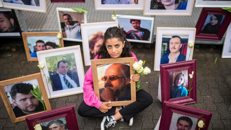 Syrian campaigner Wafa Mustafa holds a picture of her missing father. AFP