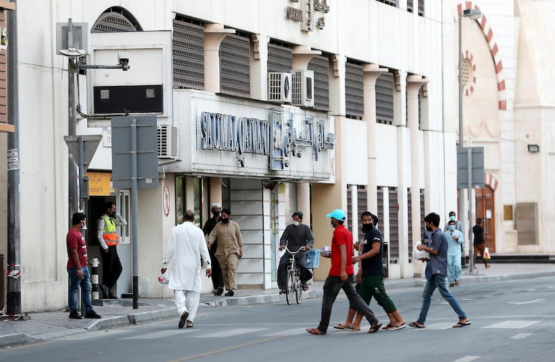 DUBAI, UNITED ARAB EMIRATES , April 27 – 2020 :- People walking on the streets in Al Ras area in Deira Dubai. Authorities ease the restriction for the residents after almost a month long locked down of Al Ras district. (Pawan Singh / The National) For News/Standalone/Online/Instagram