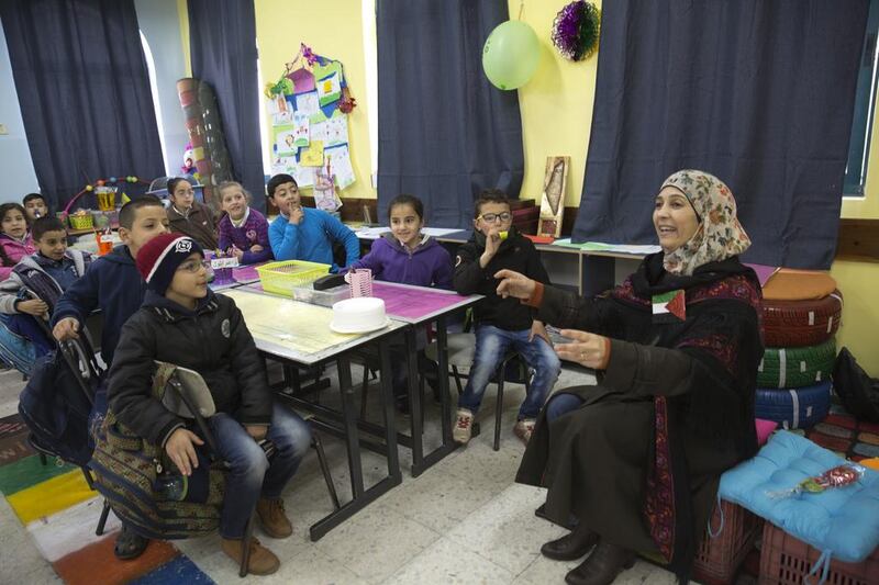 Teacher Hanan Al Hroub addresses her class of mostly seven-year-olds on her first day back at Samiha Khalil school, just outside Ramallah, after winning the second annual $1 million (Dh3.67m) Varkey Foundation Global Teacher Prize earlier in the month. Heidi Levine for The National